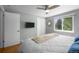 Bright bedroom featuring hardwood floors, sliding door closet and a ceiling fan at 2430 S Ogden St, Denver, CO 80210