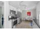 Bright kitchen featuring stainless steel appliances, white cabinets, and modern lighting at 2430 S Ogden St, Denver, CO 80210