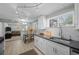 Updated kitchen with breakfast bar and open view into the living room at 2430 S Ogden St, Denver, CO 80210