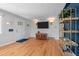 Open-concept living room featuring hardwood floors, modern lighting, and a bright entryway at 2430 S Ogden St, Denver, CO 80210
