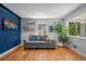 Comfortable living room with hardwood floors, neutral sofa, and stylish accents at 2430 S Ogden St, Denver, CO 80210