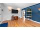 Inviting living room with hardwood floors, modern lighting, and stylish shelving at 2430 S Ogden St, Denver, CO 80210