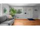 Sunlit living room featuring hardwood floors, neutral sofa, and a welcoming atmosphere at 2430 S Ogden St, Denver, CO 80210