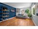 Comfortable living room with hardwood floors, a neutral sofa, and ample natural light at 2430 S Ogden St, Denver, CO 80210