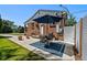 Brick home features a cozy patio with an outdoor dining set and an umbrella, perfect for relaxing and dining al fresco at 2430 S Ogden St, Denver, CO 80210