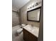 Updated bathroom featuring vanity, tile shower and new light fixture at 16136 E Exposition Dr, Aurora, CO 80017