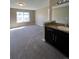 Spacious bedroom featuring bathroom vanity and large window at 16136 E Exposition Dr, Aurora, CO 80017