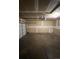 Empty garage with concrete floors and unfinished drywall at 16136 E Exposition Dr, Aurora, CO 80017