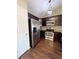 Close up of kitchen featuring stainless steel appliances, granite countertops and dark wood cabinets at 16136 E Exposition Dr, Aurora, CO 80017