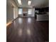 Living room has vaulted ceiling with skylights, wood floors and a brick fireplace at 16136 E Exposition Dr, Aurora, CO 80017