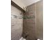 Shower featuring decorative tile and updated fixtures at 16136 E Exposition Dr, Aurora, CO 80017