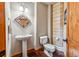 This powder room features a pedestal sink, unique mirror and wood accent wall at 351 Kimmes Ln, Breckenridge, CO 80424