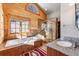Luxurious bathroom featuring a soaking tub, tiled shower, vanity, and a large window at 351 Kimmes Ln, Breckenridge, CO 80424