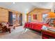 Bedroom featuring log walls, curtains, and two view windows at 351 Kimmes Ln, Breckenridge, CO 80424
