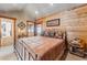 Bedroom featuring log walls, bed, and balcony access at 351 Kimmes Ln, Breckenridge, CO 80424