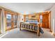 Charming bedroom with wood-paneled walls, log-style bed frame, and scenic mountain views at 351 Kimmes Ln, Breckenridge, CO 80424