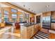 Open concept living room with a stone fireplace, wood beams and mountain views at 351 Kimmes Ln, Breckenridge, CO 80424