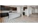Modern kitchen with dark cabinets, island, and stainless steel appliances at 5700 Ranch St, Mead, CO 80504