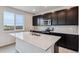 Modern kitchen with dark cabinets, quartz countertops and stainless steel appliances at 5700 Ranch St, Mead, CO 80504