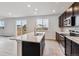 Modern kitchen features island, stainless steel appliances, and backyard views at 5700 Ranch St, Mead, CO 80504
