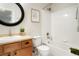 Well-lit bathroom features a shower over the bathtub, vanity with cabinet, and framed art at 7777 E 23Rd Ave # 401, Denver, CO 80238