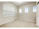 Bright bedroom features neutral carpet, three windows, and a light-colored wall at 7777 E 23Rd Ave # 401, Denver, CO 80238