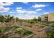 Community garden featuring raised garden beds, walking paths, and mature landscaping at 7777 E 23Rd Ave # 401, Denver, CO 80238
