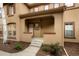 Inviting entrance showcasing a covered porch with stucco pillars and a landscaped yard at 7777 E 23Rd Ave # 401, Denver, CO 80238