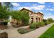 A charming multi-story condo with lush landscaping and a well-maintained walkway at 7777 E 23Rd Ave # 401, Denver, CO 80238