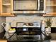 Close up of modern kitchen with stainless steel appliances, natural tone cabinets and granite countertops at 7777 E 23Rd Ave # 401, Denver, CO 80238