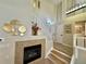 The living room features a gas fireplace, an open staircase to the second floor, and is flooded with natural light at 7777 E 23Rd Ave # 401, Denver, CO 80238