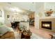 Inviting living room is adjacent to the kitchen and dining area, and has a cozy fireplace at 7777 E 23Rd Ave # 401, Denver, CO 80238