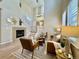 Inviting living room features a cozy fireplace, wood floors, and an open staircase to the second floor at 7777 E 23Rd Ave # 401, Denver, CO 80238