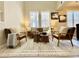 Comfortable living room boasts lots of natural light, neutral paint, and plush chairs and sofa at 7777 E 23Rd Ave # 401, Denver, CO 80238