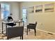 Bright office space with neutral walls, a modern desk, and two comfortable guest chairs at 7777 E 23Rd Ave # 401, Denver, CO 80238