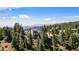 Home nestled on a tree-covered mountainside offering breathtaking panoramic views from its balconies at 251 Ridgeview Ln, Boulder, CO 80302