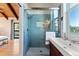 Well-lit bathroom with glass enclosed shower, modern fixtures, and scenic views from the window at 251 Ridgeview Ln, Boulder, CO 80302