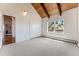 Bright bedroom featuring vaulted wood ceilings, a large window, and neutral carpet floors at 251 Ridgeview Ln, Boulder, CO 80302