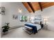 Comfortable bedroom featuring vaulted ceilings, wood beams, and ample natural light from the window at 251 Ridgeview Ln, Boulder, CO 80302