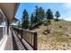 Outdoor deck showcasing panoramic wooded views with a traditional wooden railing at 251 Ridgeview Ln, Boulder, CO 80302