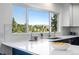 Bright kitchen featuring a large window with scenic mountain views and modern finishes at 251 Ridgeview Ln, Boulder, CO 80302