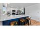Modern kitchen with an eat-in island, white cabinets, stainless steel appliances, and sleek countertops at 251 Ridgeview Ln, Boulder, CO 80302