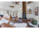 Cozy living room with a stone fireplace, exposed beams, and rustic decor at 251 Ridgeview Ln, Boulder, CO 80302