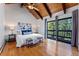 Inviting main bedroom featuring vaulted ceilings, wood beams, and large windows with scenic views at 251 Ridgeview Ln, Boulder, CO 80302