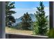 Breathtaking mountain views framed by lush evergreen trees seen from a window at 251 Ridgeview Ln, Boulder, CO 80302