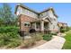 Two-story townhome with stone and siding exterior, patio, and walkway at 1879 S Buchanan Cir, Aurora, CO 80018