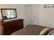 Bedroom featuring a dresser with mirror, storage and neutral colors for a relaxing atmosphere at 22345 E Bailey Pl, Aurora, CO 80016