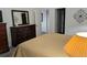 Bedroom showcasing a dresser with mirror, doorway and neutral colors for a serene atmosphere at 22345 E Bailey Pl, Aurora, CO 80016