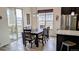 Bright dining space featuring a modern table, large windows, and sleek vinyl plank flooring at 22345 E Bailey Pl, Aurora, CO 80016
