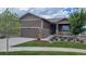 Charming single-Gathering home with a well-manicured lawn, stone accents, and an attached two-car garage at 22345 E Bailey Pl, Aurora, CO 80016